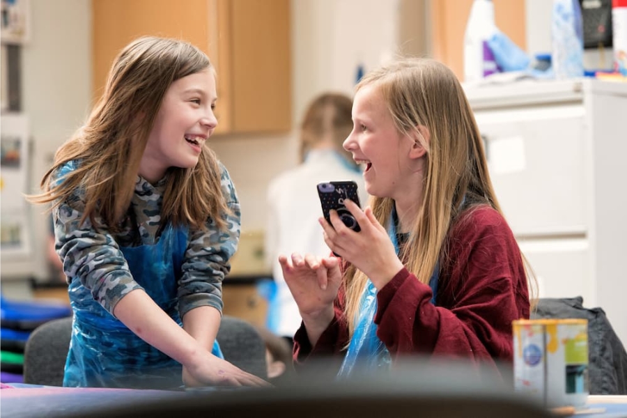 15 Two teenage girls at a creative workshop in a library