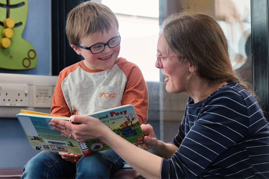 17 A mother and child reading together in a library