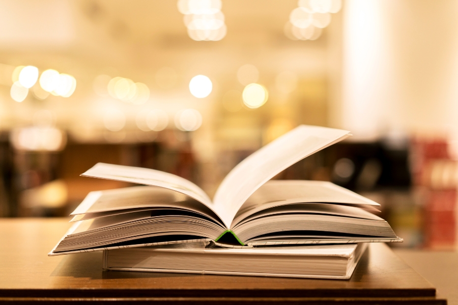 pile of books in foreground blurred background