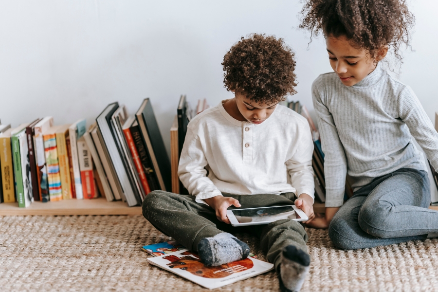 Two kids reading on a tablet