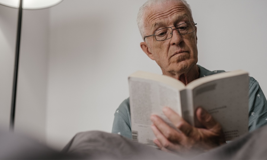 elderly man reading at home
