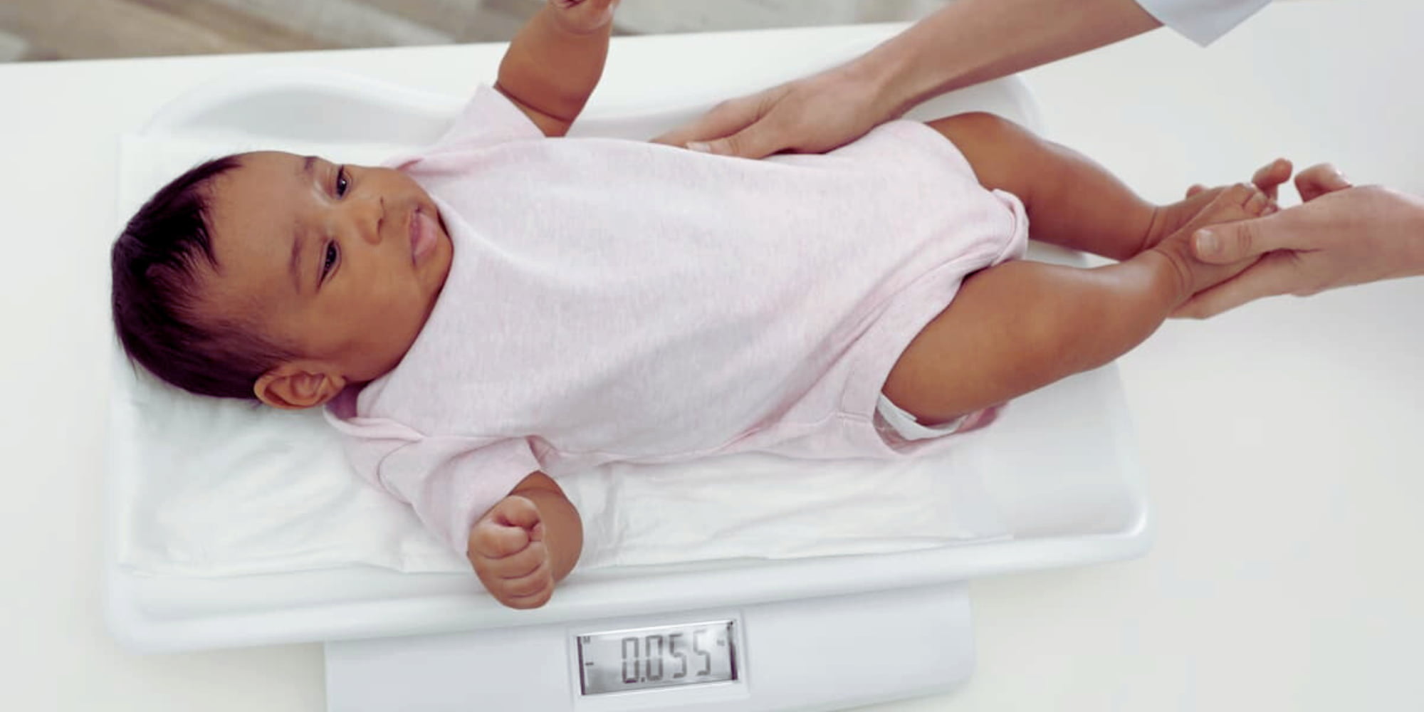 Baby weighing 2x1 resize A young baby being weighed on a scale