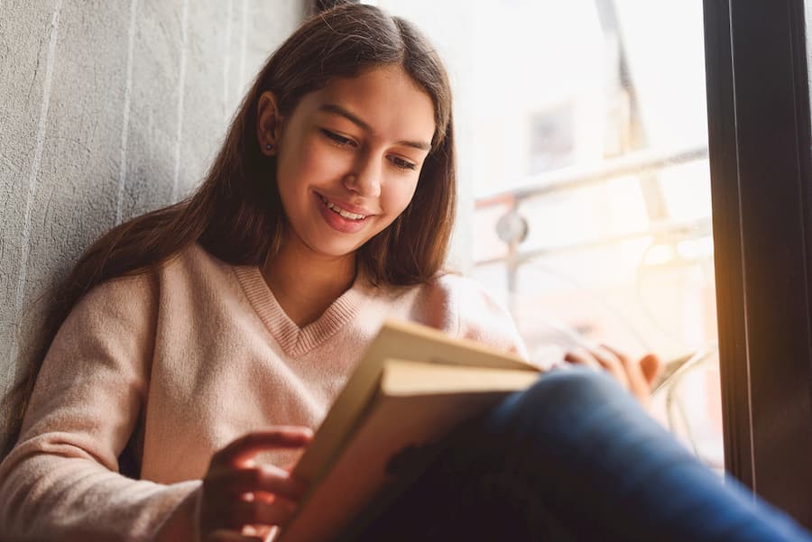 Teen reading a book