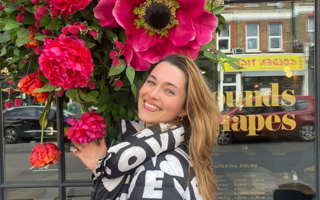 Charlotte McGuiness with some colourful flowers