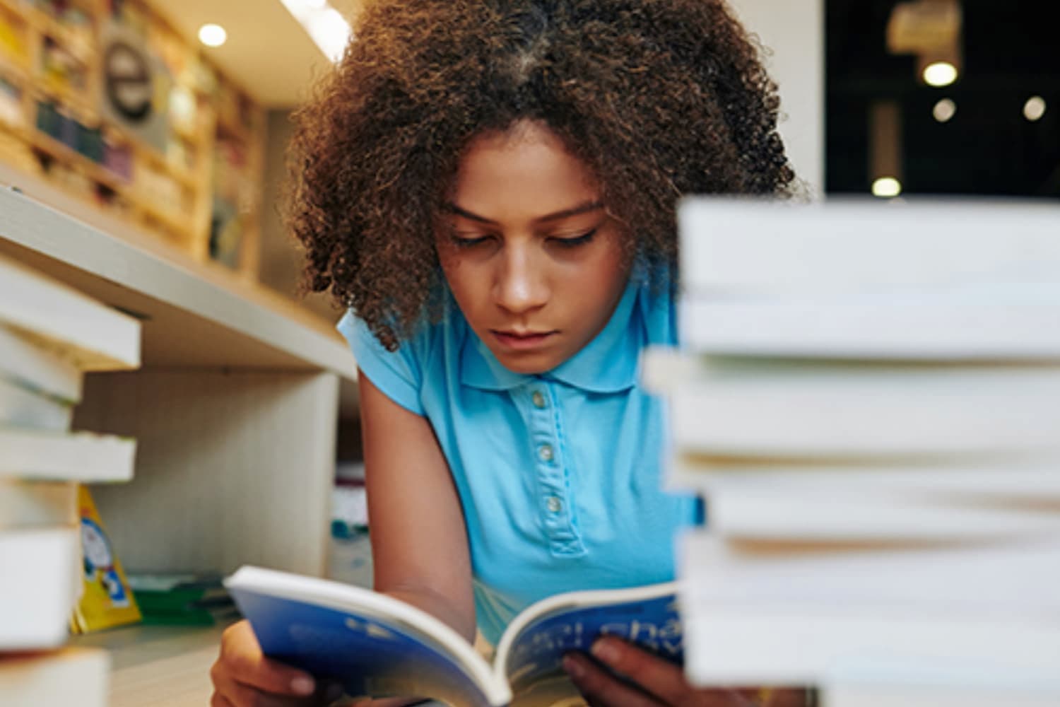 Childrens homework stock 3x2 resize A child reading books and doing homework