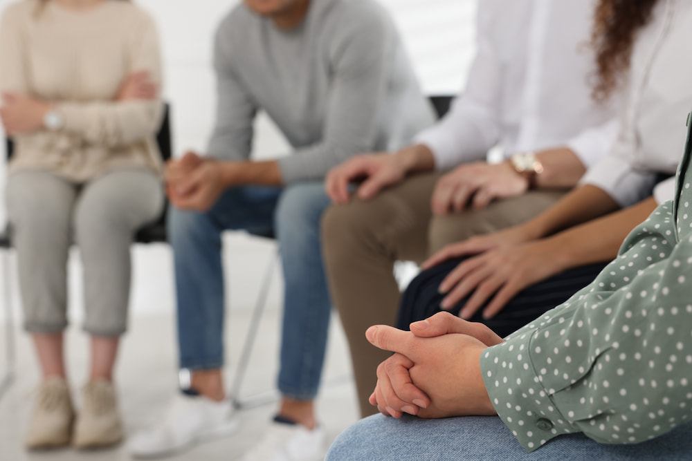 Group support session stock resize People sat talking at a group support session