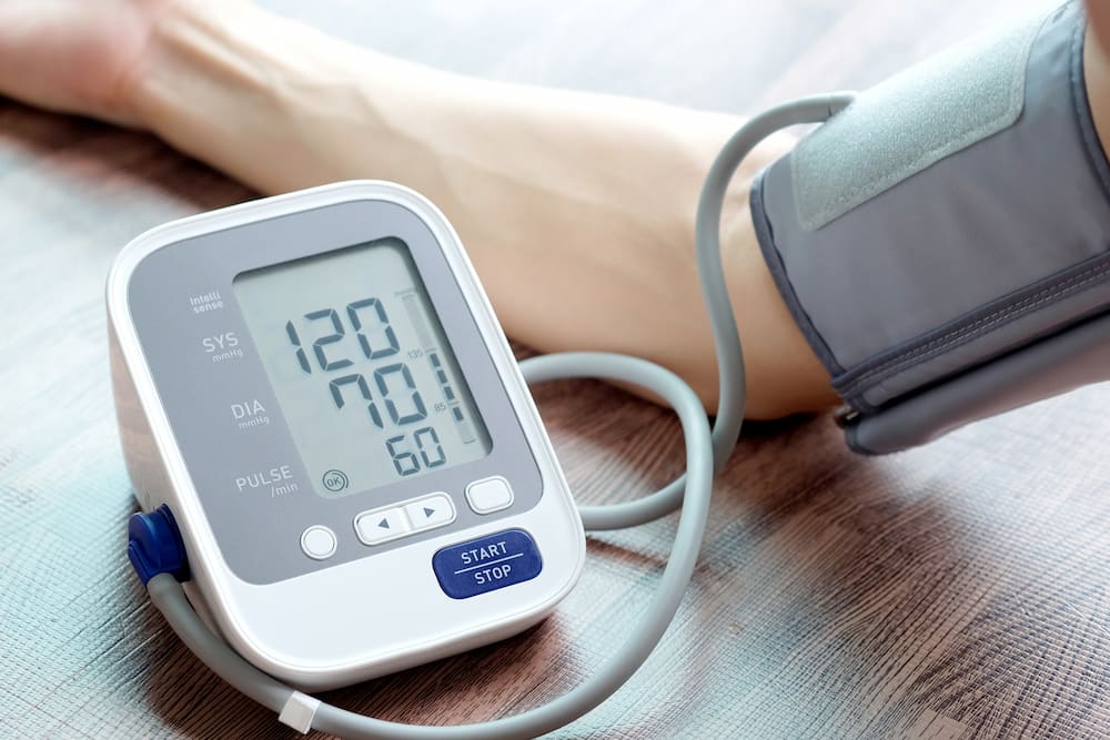 Man checking blood pressure monitor stock resize Man checking his blood pressure using a monitor