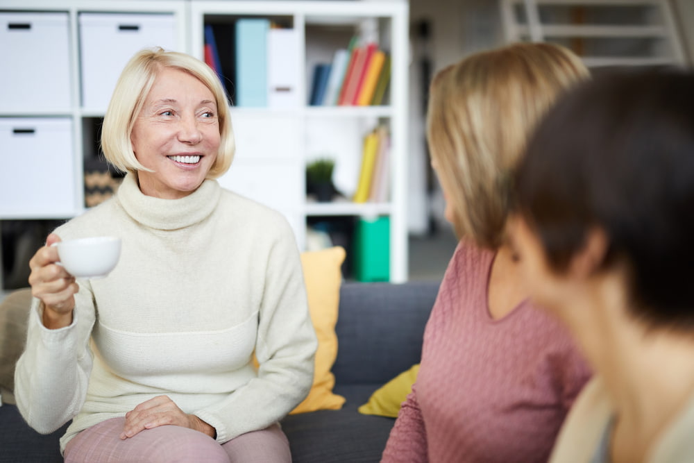 Middle aged women chatting and smiling stock resize Middle aged women chatting and smiling stock resize