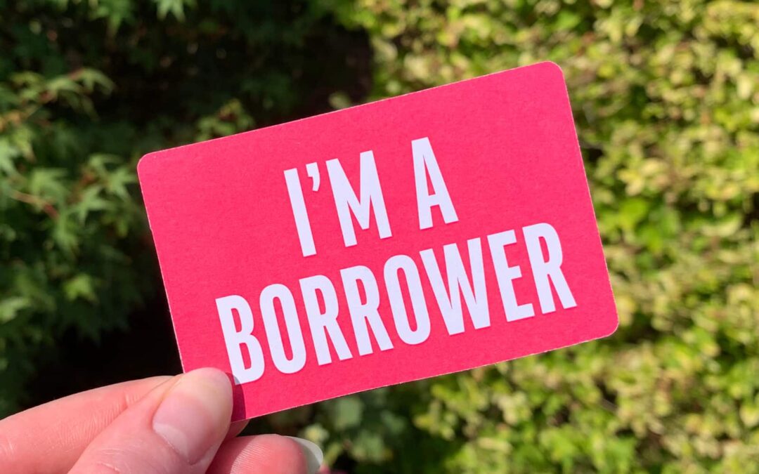 A pink library card with the text 'I'M A BORROWER' on it