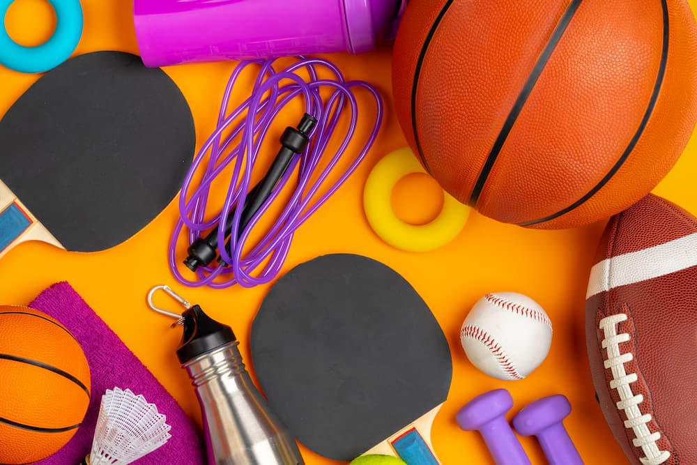 Sports equipment stock resize Various sports equipment on an orange floor