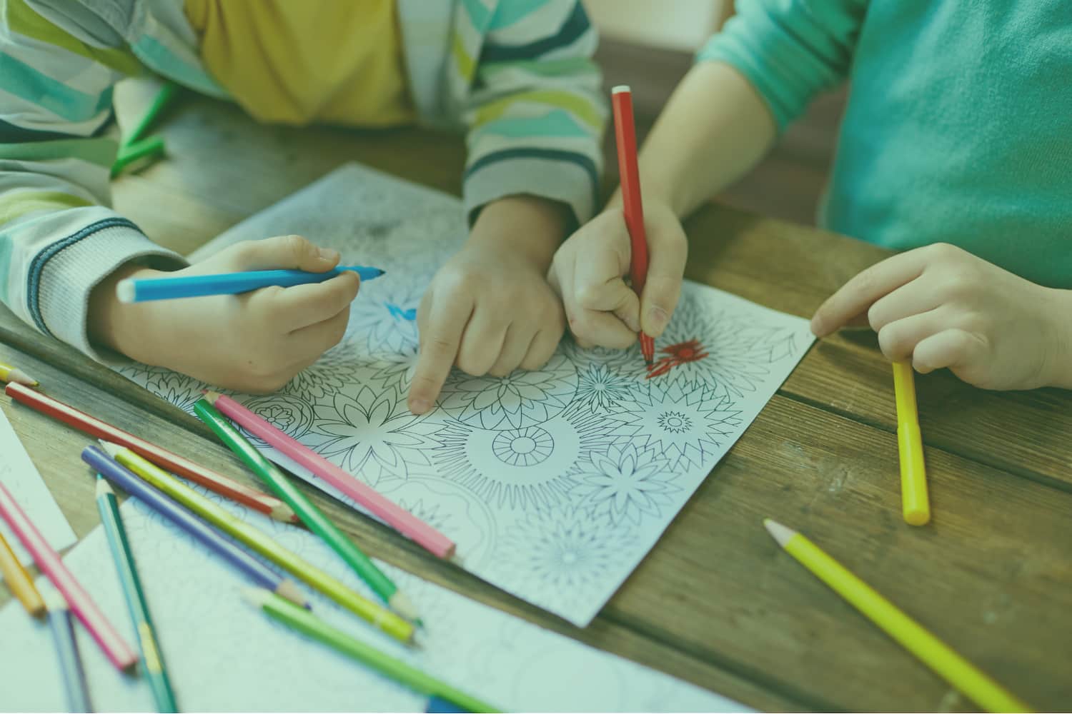 Young children colouring in green overlay resize Close-up of young children colouring in with pens