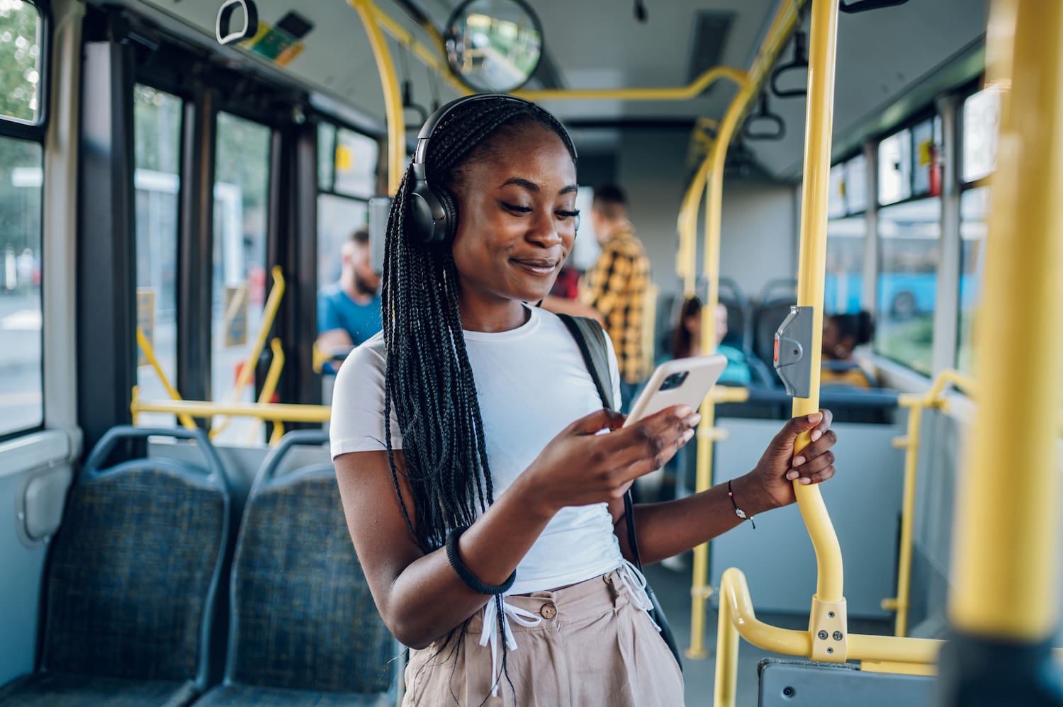 A woman listening to music on a bus