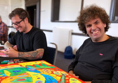 A group of attendees at a Brave Art group in the library