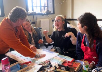 A group of attendees at a Brave Art group in the library