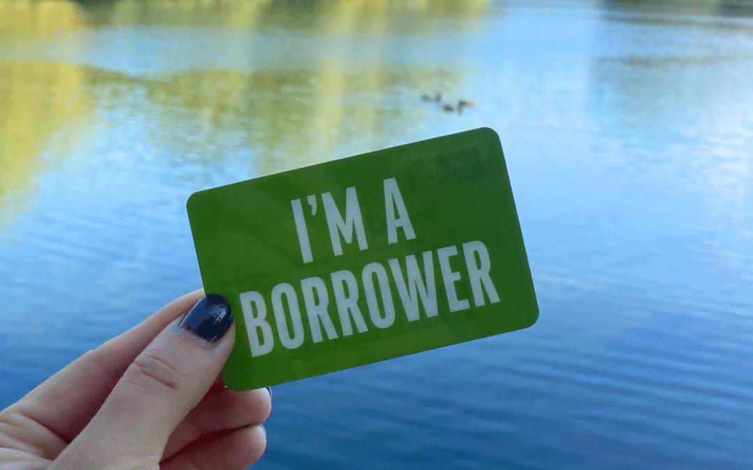 A green library card with the text 'I'M A BORROWER' on it