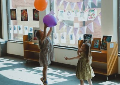 Children playing with balloons in the foyer of Lowestoft Library during their 50th birthday celebrations.