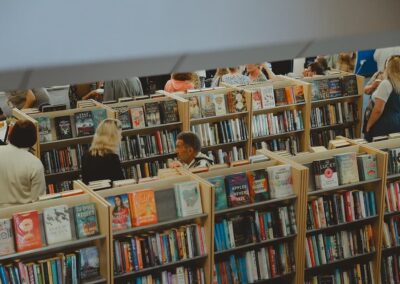 Attendees at Lowestoft Library's 50th birthday celebrations walking among the bookshelves.