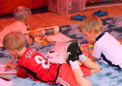 A group of boys enjoying colouring and reading activities