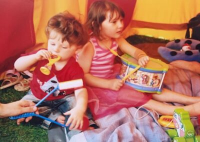 Children enjoying musical instruments in the libraries tent